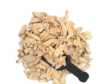 May include: A pile of dried licorice root slices, a traditional Chinese medicine, with a black scoop.