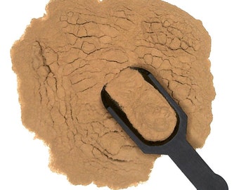 May include: A brown powder with a black scoop. The powder is in a pile and the scoop is partially submerged in the powder.