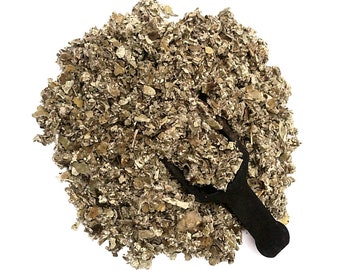 May include: A close-up of a pile of dried, light brown, and green herbs with a black scoop.