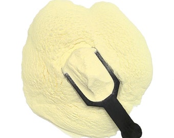 May include: A scoop of yellow powder with a black plastic scoop on top.