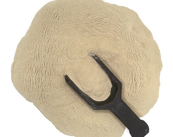 May include: A scoop of beige powder with a black plastic scoop on top.