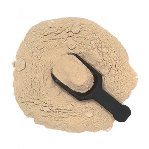 May include: A scoop of light brown powder with a black plastic scoop on top.