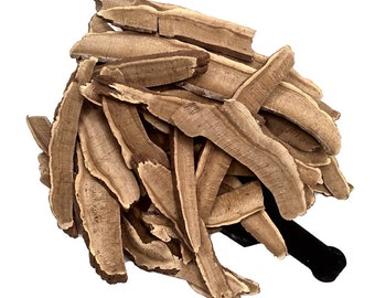 May include: A pile of dried, light brown reishi mushroom slices. The slices are thin and have a slightly curved shape.