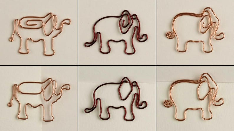 K&ouml;nnte beinhalten: Sechs Drahtskulpturen von Elefanten, drei in Kupfer und drei in Rot, sind in einem Gittermuster angeordnet. Jeder Elefant besteht aus einem einzigen Drahtst&uuml;ck und hat einen eingerollten R&uuml;ssel.
