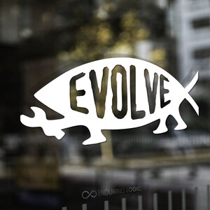 May include: White graphic of the word "EVOLVE" inside a stylized fish shape, applied to a glass surface. The logo is set against a blurred background of a building exterior. The words "Enduring Logic" are in the upper left and lower right corners.
