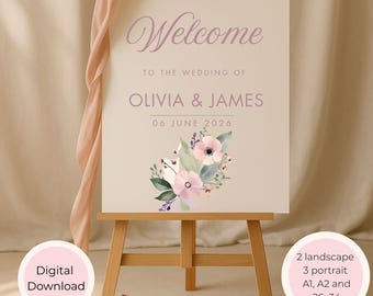 Peut inclure: Panneau de bienvenue de mariage sur un chevalet en bois. Le panneau crème porte l'inscription "Welcome" en violet clair. Il indique ensuite "TO THE WEDDING OF OLIVIA & JAMES 06 JUNE 2026." Un arrangement floral orne le bas. Un ruban rose est drapé.