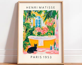 May include: A framed print of a painting by Henri Matisse titled "Paris 1953". The painting depicts a yellow bathtub with a black cat sitting in front of it. The bathtub is surrounded by lush green plants and pink flowers. The painting is set in a tropical garden with a blue door in the background.