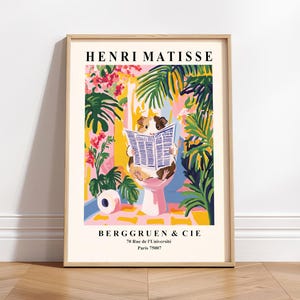 May include: A framed art print featuring a guinea pig reading a newspaper while sitting on a pink toilet. The print has a colorful floral and tropical background with the text "HENRI MATISSE" and "BERGGRUEN & CIE" at the top and bottom.