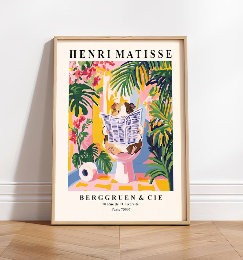 May include: A framed art print featuring a guinea pig reading a newspaper while sitting on a pink toilet. The print has a colorful floral and tropical background with the text "HENRI MATISSE" and "BERGGRUEN & CIE" at the top and bottom.