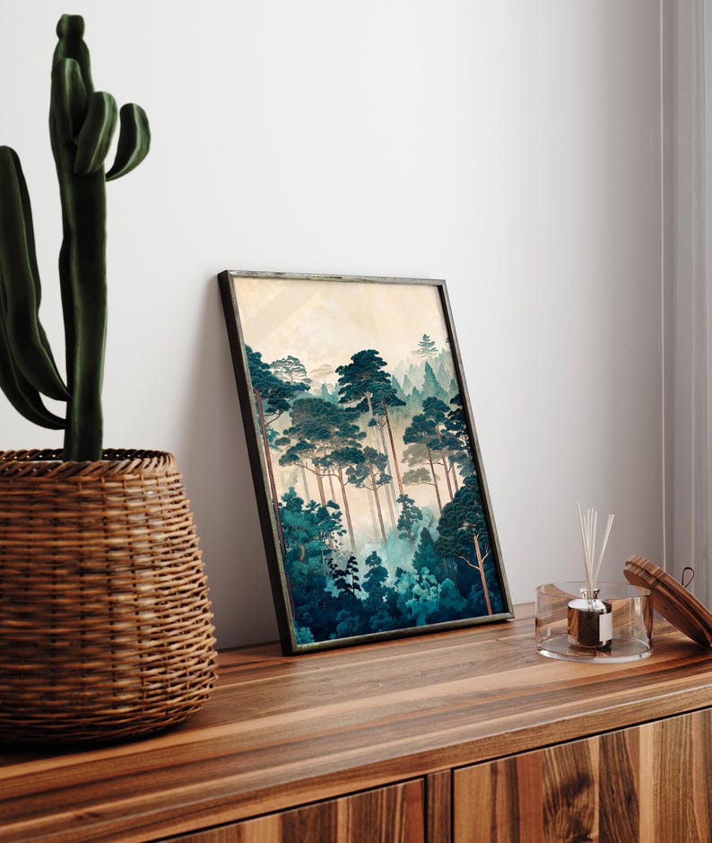 May include: A framed print of a forest scene with tall, dark green trees and a misty background. The print is in a black frame and is hanging on a wall.
