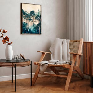 May include: A wooden chair with a woven cane seat and back, a white throw blanket draped over the seat, and a framed print of a forest scene hanging on the wall behind the chair.