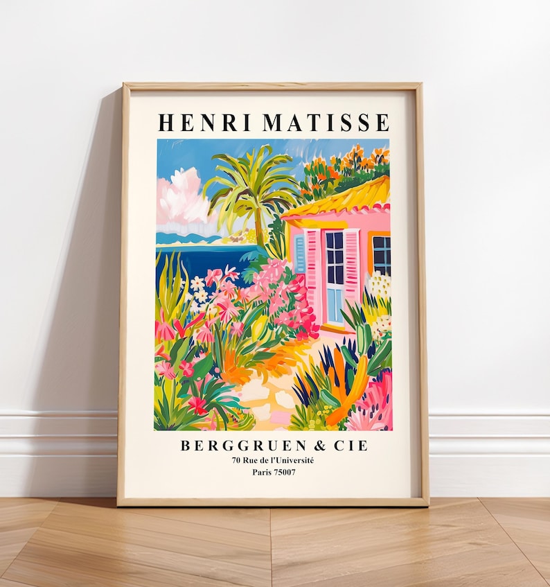 May include: A framed print of a painting by Henri Matisse depicting a pink house with a palm tree and flowers in a garden. The text "Henri Matisse" and "Berggruen & Cie" is printed below the image. The address "70 Rue de l'Universit&eacute; Paris 75007" is printed below the company name.
