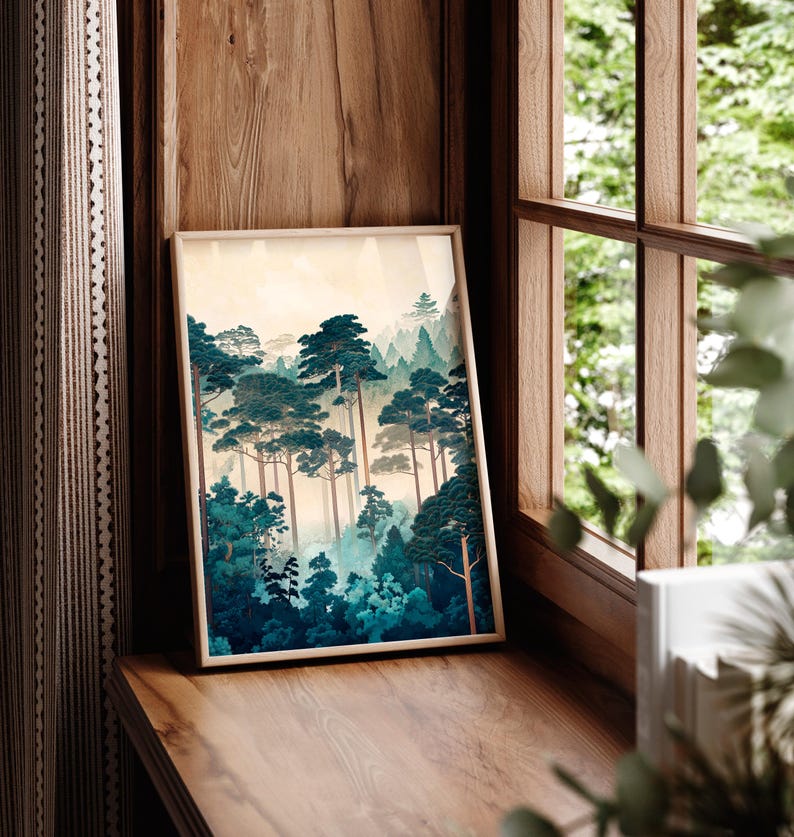 May include: A framed print of a forest scene with tall, dark green trees and a misty background. The print is in a light wood frame and is hanging on a wooden wall.