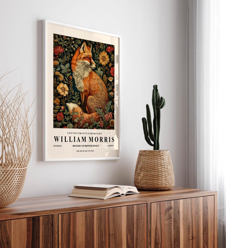 May include: A framed poster with a vintage aesthetic featuring a red fox surrounded by flowers. The poster is titled "COTTON PRINTS EXHIBITION WILLIAM MORRIS TEXTILES HISTORY OF BRITISH DESIGN THE ART OF SIX CENTURIES".