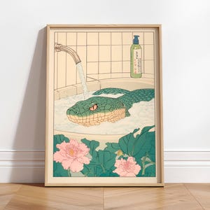 May include: A framed illustration of a green snake in a bathtub with bubbles. The snake has a red eye and is looking at the viewer. There is a bottle of bath soap on the ledge of the tub. The illustration is in a Japanese style with pink flowers and green leaves.