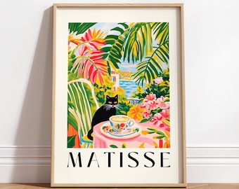 May include: A framed print of a painting by Henri Matisse. The painting depicts a black cat sitting on a chair in a lush tropical garden setting. A cup of coffee sits on a table in front of the cat. The text "MATISSE" is printed below the image.
