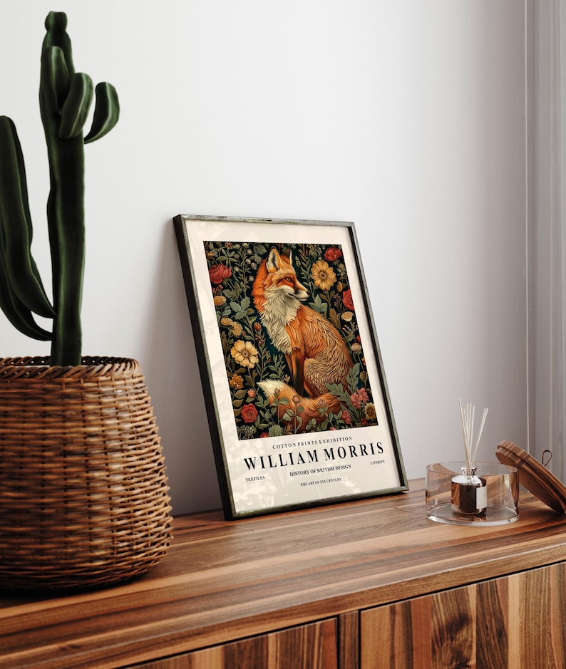 May include: A framed print featuring a fox surrounded by flowers. The print is titled "William Morris" and includes the text "Cotton Prints Exhibition, History of Textile Design, The Art of the 19th Century".