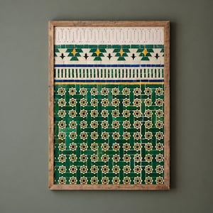 May include: A rectangular wall art piece featuring a mosaic tile pattern in shades of deep green, white, yellow, and blue, enclosed in a light brown wooden frame. The design includes geometric star motifs and horizontal bands of intricate tile work.
