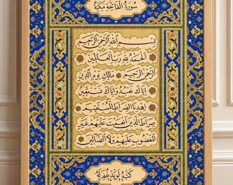 May include: A framed rectangular wall art piece featuring intricate Islamic calligraphy in black ink on a textured beige background. The artwork is surrounded by a vibrant blue and gold floral border with detailed patterns and a light wood frame.