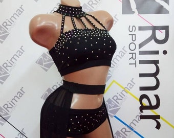 May include: A black dance costume with a halter top, shorts, and a sheer skirt. The top and shorts are embellished with rhinestones. The costume is designed for dance performances.
