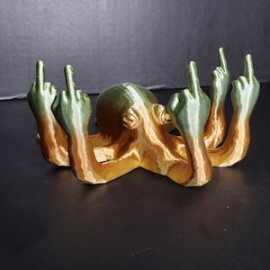 May include: A 3D printed octopus figurine with eight arms, each ending in a middle finger gesture. The octopus is painted in a gradient of green, gold, and brown.