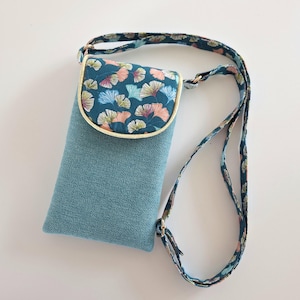 cell phone pouch with adjustable shoulder strap for smartphone or iPhone quilted in gingko cotton on a petrol and lagoon canvas background