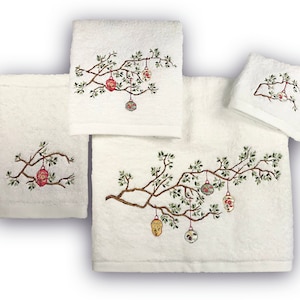 May include: Set of four white bath towels with embroidered Christmas ornaments hanging from a branch. The towels are made of soft, absorbent cotton.