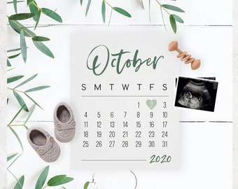 May include: A printable calendar for October 2020 with a green heart on the second, a sonogram image, and baby booties. The text "October" is in a cursive font. The text "Add your own sonogram, pictures & text to announce your pregnancy on social media. Sonograms can be removed completely, change the calendar dates/month/year. All text colors can be changed! Make it yours!" is at the bottom of the calendar.
