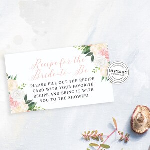 May include: A white card with pink floral designs and the text "Recipe for the Bride-to-Be" and "Please fill out the recipe card with your favorite recipe and bring it with you to the shower!"