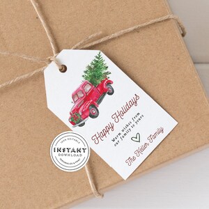 May include: Red truck with a Christmas tree in the back, a gift tag with the text "Happy Holidays" and "Warm wishes from our family to yours" and the text "The Keller Family".