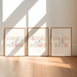 May include: Three framed prints with colorful text. The prints read "Dance in the Mirror", "Sing in the Shower", and "Splash in the Bath".