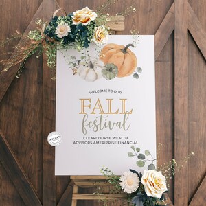 May include: A white sign with the words "Welcome to our Fall Festival" in gold lettering. The sign is decorated with watercolor illustrations of pumpkins, leaves, and flowers. The sign is on a wooden easel.