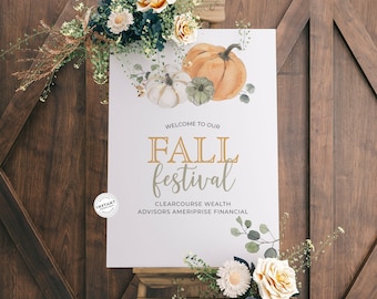 May include: A white sign with the words "Welcome to our Fall Festival" in gold lettering. The sign is decorated with watercolor illustrations of pumpkins, leaves, and flowers. The sign is on a wooden easel.