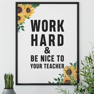 May include: Black framed print with a white background and the text "Work Hard & Be Nice To Your Teacher". The print is decorated with yellow sunflowers and green leaves.