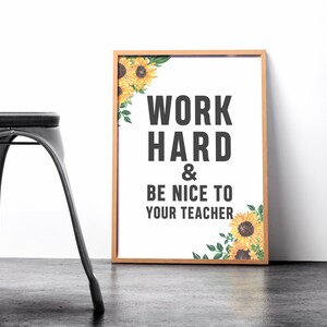 May include: A framed print with a white background and black text that reads "Work Hard & Be Nice To Your Teacher". The print is decorated with a sunflower border.