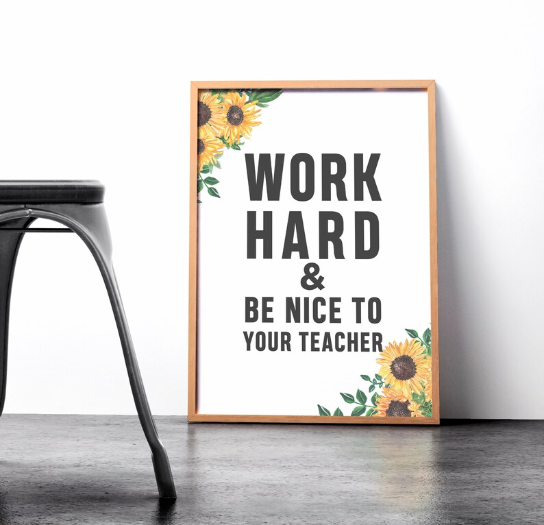 May include: A framed print with a white background and black text that reads "Work Hard & Be Nice To Your Teacher". The print is decorated with a sunflower border.