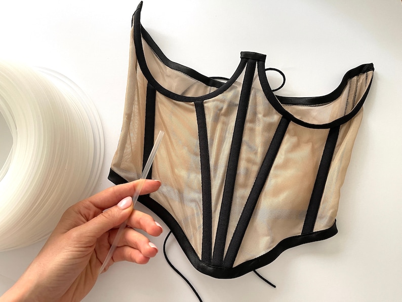 Transparent plastic boning used in a corset, providing invisible support and structure
