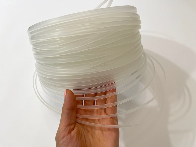 Flexible transparent plastic corset boning demonstrating bendable structure for comfortable wear