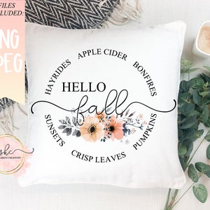 May include: White throw pillow with a black circle design that says "Hello Fall" with a floral design in the center. The circle also has the words "Hayrides", "Apple Cider", "Bonfires", "Sunsets", "Crisp Leaves", and "Pumpkins" around the outside.