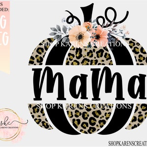May include: A black and gold pumpkin with a leopard print design and the word "Mama" in black text. The pumpkin is decorated with a floral arrangement of pink and white flowers.