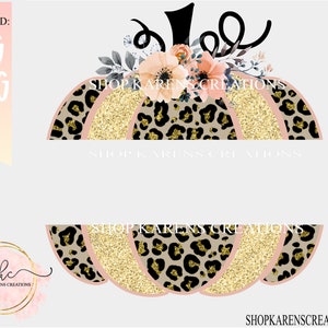 May include: A pink and gold pumpkin with a leopard print design and floral accents. The pumpkin is decorated with gold glitter and has the text "Shop Karen's Creations" on it.
