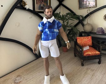 Traje de licra para muñeca de 15 cm a escala 1:12. Incluye pantalón corto, camiseta de manga corta con cuello estampado, muñequera y zapatos blancos.
