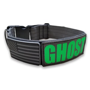 May include: A gray dog collar with a black and white American flag patch and a green patch with the word "GHOST" in white letters.