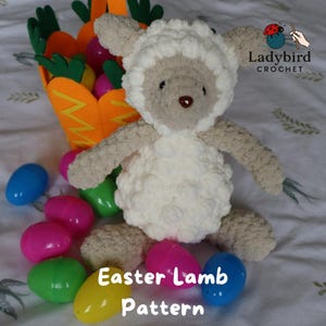 May include: A white ceramic mug with a black handle and the text "But First, Coffee" in a bold, black font. The mug is set against a blurred background, suggesting a cozy setting.