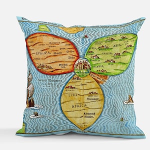 May include: A decorative throw pillow featuring a vintage map design. The map is divided into three sections, with Europe, Asia, and Africa prominently displayed. The pillow has a light blue background with a detailed, colorful map.