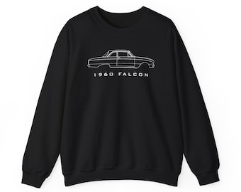 May include: A black long-sleeve sweatshirt featuring a white line art illustration of a 1960 Falcon car profile. The text 1960 FALCON is printed in white capital letters directly below the car graphic, centered on the chest of the garment.