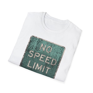 May include: White t-shirt featuring a distressed teal and white "NO SPEED LIMIT" road sign graphic. The design has a vintage, weathered look. The shirt is made of a soft, comfortable material.