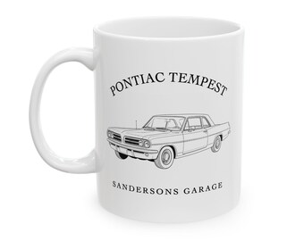 May include: White ceramic mug featuring a black line drawing of a vintage Pontiac Tempest car. The text "Pontiac Tempest" is above the car, and "Sandersons Garage" is below.