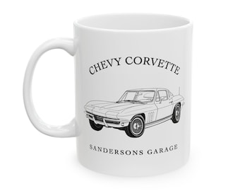 May include: White ceramic mug featuring a black line drawing of a classic Chevy Corvette. The text "CHEVY CORVETTE" arches above the car image, with "SANDERSONS GARAGE" below. The mug has a curved handle.