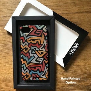 May include: A black phone case with a colorful geometric pattern. The case is in a black box with a white interior. The text "Hand Painted Option" is visible below the box.
